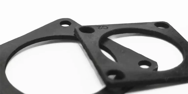 Ce gros plan présente deux joints noirs aux découpes circulaires, superposés sur un fond blanc immaculé. Doté de petits trous près des bords, peut-être à des fins de fixation ou dalignement, le marquage de précision du silicone ajoute une touche dingénierie méticuleuse.